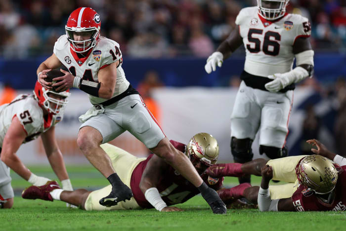 Dec 30, 2023; Miami Gardens, FL, USA; Georgia Bulldogs quarterback Gunner Stockton (14) rushes the ball against the Florida State Seminoles during the second half in the 2023 Orange Bowl at Hard Rock Stadium. Mandatory Credit: Nathan Ray Seebeck-USA TODAY Sports